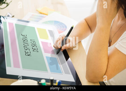 web designer working on a tablet. All screen graphics are made up. Stock Photo