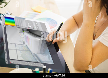 interior designer working on a tablet. All screen graphics are made up. Stock Photo