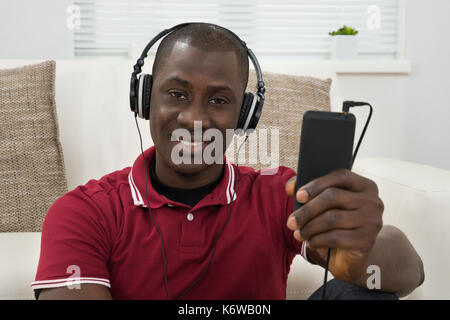 Portrait Of Young African Man Listening Music On Headphones Stock Photo