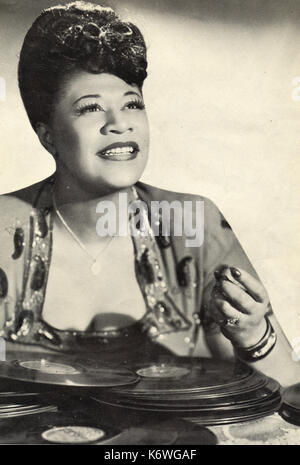 FITZGERALD, Ella with pile of records in front of her in 1940s American Jazz /blues singer Stock Photo