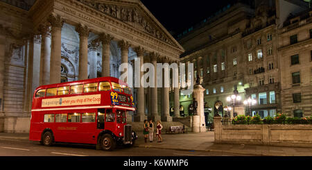 Classic London Double Decker Red Bus at night in the City of London Stock Photo