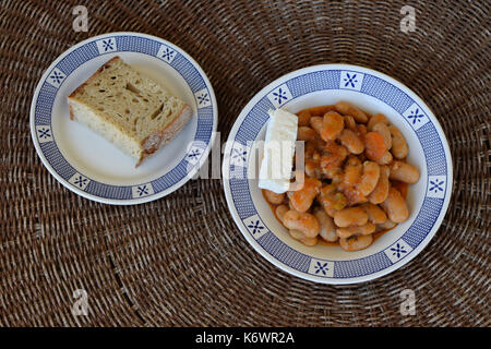 Baked giant beans gigantes with feta cheese and bread. Greek food. Stock Photo