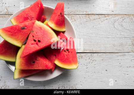 Watermelon slice popsicles on a rustic wood background Stock Photo