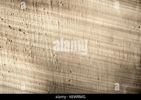 Retro background. Old plastered flat surface with cracks and streaks of light and shadow on her. Stock Photo