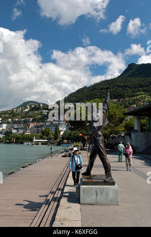 Freddie Mercury's statue is placed on the edge of Lake Geneva in Montreux, Switzerland, Europe. He stands and faces the calm waters of the lake from t Stock Photo