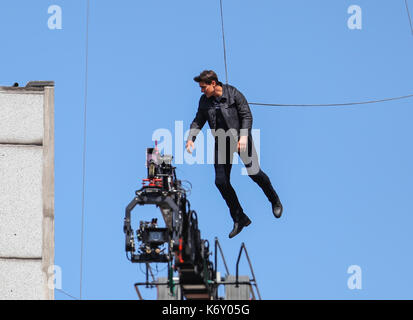 Tom Cruise jumps between two buildings in a scene from the new Mission Impossible film  The 55-year-old action man was injured during a big building-jump stunt on the set of the blockbuster in London on Sunday (13Aug17) - which was caught on camera. Cruise appeared to miss his mark while jumping from construction rigging onto a nearby building, and slammed gainst the wall. Clambering up the wall and getting to his feet, the movie star limped for a few yards and then collapsed in front of the film crew. Filming was halted as Tom was checked out by members of the on-set safety team. The footage  Stock Photo