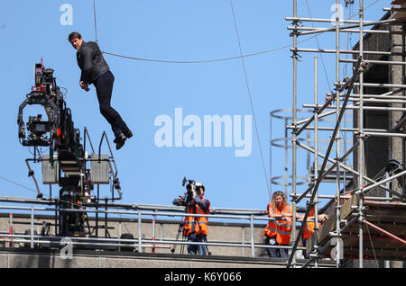 Tom Cruise jumps between two buildings in a scene from the new Mission Impossible film  The 55-year-old action man was injured during a big building-jump stunt on the set of the blockbuster in London on Sunday (13Aug17) - which was caught on camera. Cruise appeared to miss his mark while jumping from construction rigging onto a nearby building, and slammed gainst the wall. Clambering up the wall and getting to his feet, the movie star limped for a few yards and then collapsed in front of the film crew. Filming was halted as Tom was checked out by members of the on-set safety team. The footage  Stock Photo