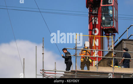 Tom Cruise jumps between two buildings in a scene from the new Mission Impossible film  The 55-year-old action man was injured during a big building-jump stunt on the set of the blockbuster in London on Sunday (13Aug17) - which was caught on camera. Cruise appeared to miss his mark while jumping from construction rigging onto a nearby building, and slammed gainst the wall. Clambering up the wall and getting to his feet, the movie star limped for a few yards and then collapsed in front of the film crew. Filming was halted as Tom was checked out by members of the on-set safety team. The footage  Stock Photo