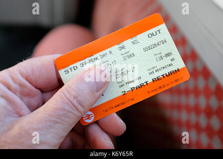 male hand holding rail travel ticket Stock Photo