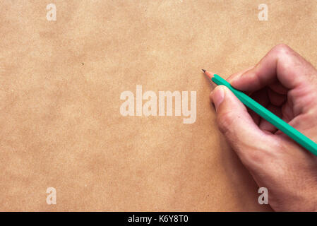 Male illustrator and sketch artist drawing with pencil, top view of  hand close up with selective focus Stock Photo