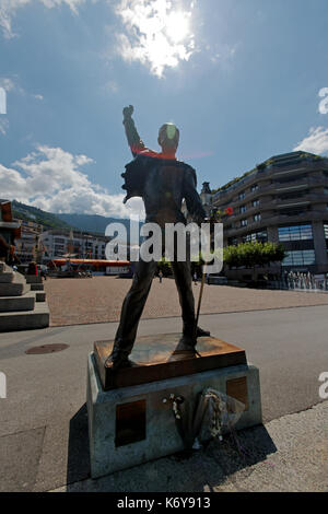 The statue of Freddie Mercury is on the waters edge of Lake Geneva in Montreux Switzerland at the base of the Swiss Alps.  In this photo, Freddie is h Stock Photo