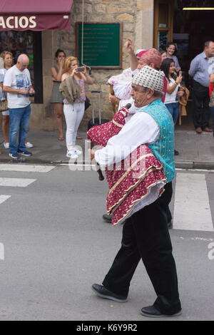 Traditional costumes during a procession with Asturian pipe bands, Banda de Gaitas, in Asturias during a fiesta Stock Photo