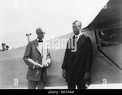 The Lone Eagle, Charles A. Lindbergh (right), stands with Henry Ford beside the 'Spirit of St. Louis,' the plane in which Col Lindbergh flew the first transatlantic solo flight in 1927. The famous flyer visited Mr. Ford in Dearborn in August 1927. Dearborn, MI, 1927. Stock Photo