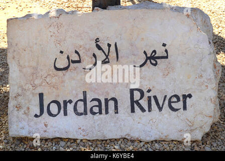 BETHANY, JORDAN - MAY 1, 2014: Jordan River sign carved in stone, in both English and Arabic. Near the site where Jesus is said to have been baptised. Stock Photo