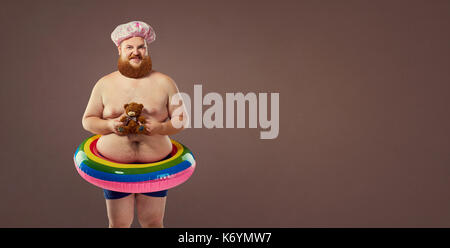 Funny fat bearded man in a swimsuit. Stock Photo