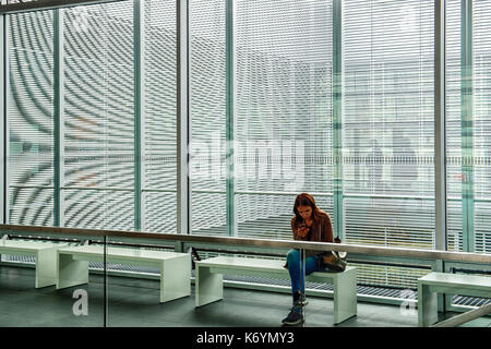 Germany A girl sitting at the entrance of the closed buiding of the Topographie des Terrors (Topography of the Terror), a permanent exhibition about the Nazis that persecuted the Jews, Berlin Stock Photo