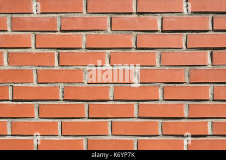 Brick wall background, texture of red stone blocks closeup Stock Photo