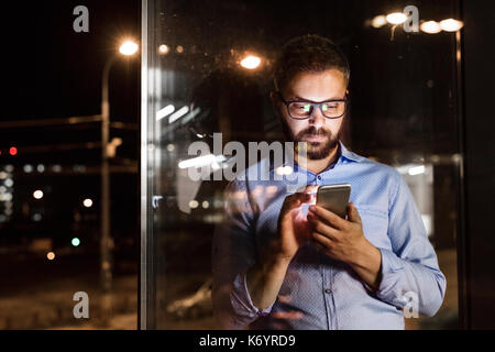 Businessman in the office at night working late. Stock Photo