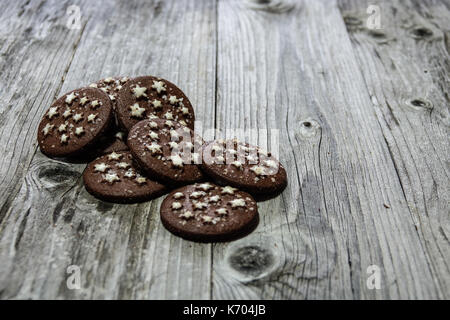 Chocolate cookies on a rustic wooden background. Closeup of a group of assorted cookies Stock Photo