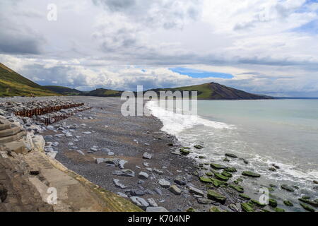 Looking South along Tanybwlch beach, Aberystwyth.  The hill at the far end is slowly being eroded away by the sea Stock Photo