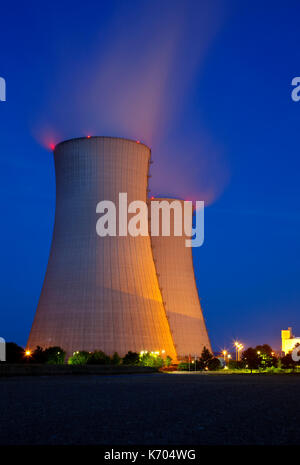 Two tall cooling towers of a nuclear power station with night blue sky. Stock Photo