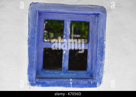 Closed vintage blue window on white wall of old house in romania Stock Photo