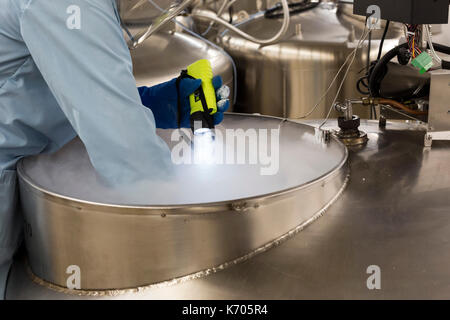 Fort Collins, Colorado - Amy Gurza, a biological science technician, inspects the contents of a tank of liquid nitrogen that stores seeds and other ge Stock Photo