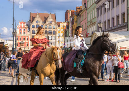 Two women on horses during a Polish folklore parade in the Old Market Square in Wroclaw in 2017, Poland Stock Photo