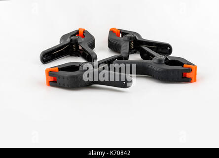 Four heavy duty clamps on a white background. Silo, cutout, cut out. Stock Photo