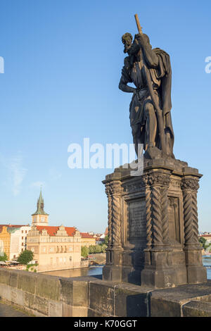 View of buildings at the Old Town and statue of Saint Christopher on the south side of the Charles Bridge (Karluv most) in Prague on a sunny day. Stock Photo