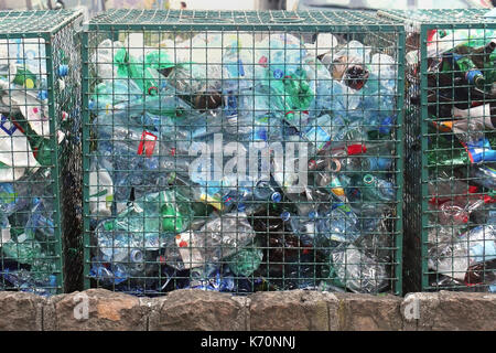 Plastic recycle center with bottles stored in metal cages Stock Photo