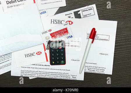 London, UK - April 14, 2015: HSBC Visa debit card activation papers with secure key delivered by mail. HSBC is one of the largest banking and financia Stock Photo