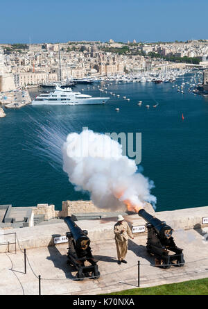 The noon cannon being fired from the Saluting Battery in Valletta, the capital of Malta. Stock Photo