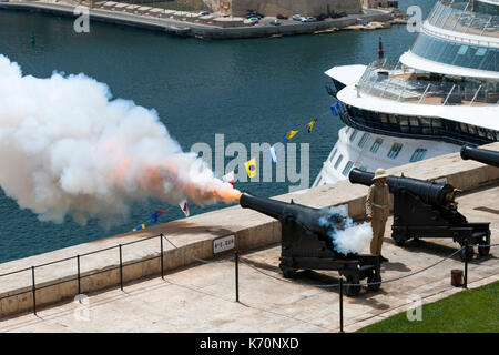 The noon cannon being fired from the Saluting Battery in Valletta, the capital of Malta. Stock Photo