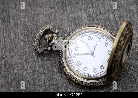 Old pocket watch on dark gray table background Stock Photo
