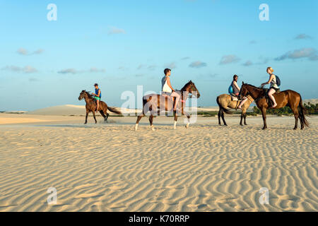 Jericoacoara, Ceara state, Brazil - July 18, 2016: Tourists ride on horseback at Sunset Dune about an hour before sunset Stock Photo