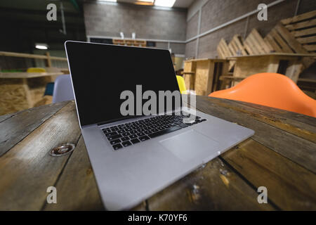 Close up of laptop on wooden table in cafe Stock Photo