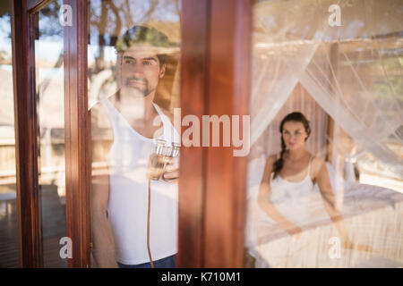 Thoughtful man looking through window during safari vacation Stock Photo