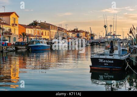 France, Gard, Le Grau du Roi, Site protected by the Conservatoire du Littoral, boats moored on the canal Stock Photo