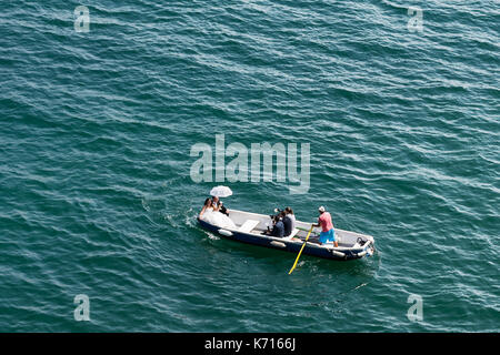 Cetara, Italy - 02 August 2017: A newly married couple in rowing boat with the staff of photographers in Amalfi Coast Stock Photo