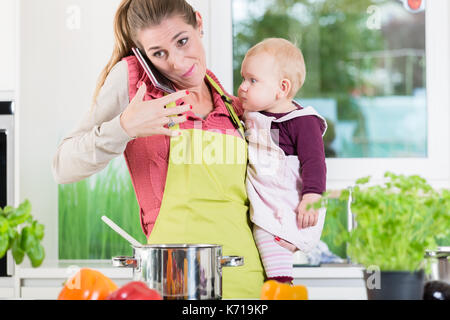 https://l450v.alamy.com/450v/k719kp/working-mom-being-stressed-by-housework-cooking-preparing-job-mobile-k719kp.jpg