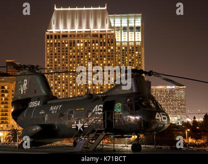 A CH-46 Sea Knight helicopter flies over Tiger Brigade M-1A1