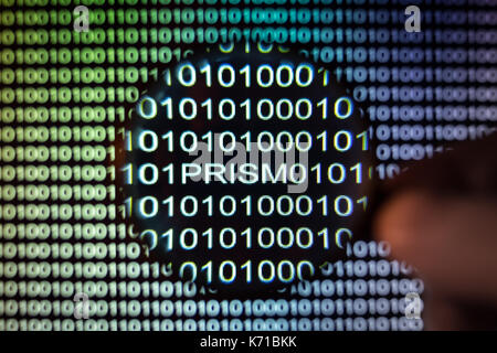 Binary code,Magnifying glass showing PRISM backdoor Stock Photo
