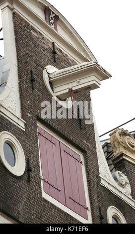 Dutch house facades and under the roof the protruding hook to lift the furniture while moving Stock Photo
