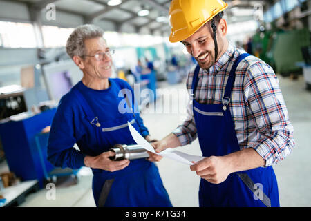 Engineer Teaching Apprentices To Use Computerized cnc metal processing machines Stock Photo