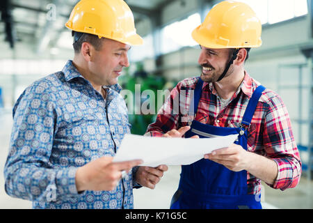 Supervisor and engineer working in metal industry Stock Photo