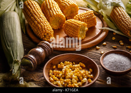Boiled sweet corn on wooden board Stock Photo