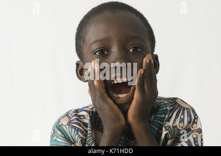Little black boy surprised and excited with white isolated background Stock Photo