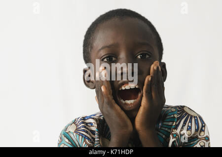 Littel African boy surprised holding his mouth open with his hands on, isolated on white Stock Photo