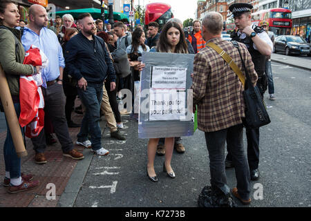 London, UK. 14th Sep, 2017. A police officer speaks to environmental activists from the Stop Killing Londoners campaign blocking Brixton Road in front of Brixton station at rush hour as part of a protest demanding urgent attention to prevent premature deaths from air pollution. Levels of nitrogen dioxide, linked to 9,500 early deaths a year in London, recorded in Brixton Road have repeatedly breached the EU limit. Credit: Mark Kerrison/Alamy Live News Stock Photo